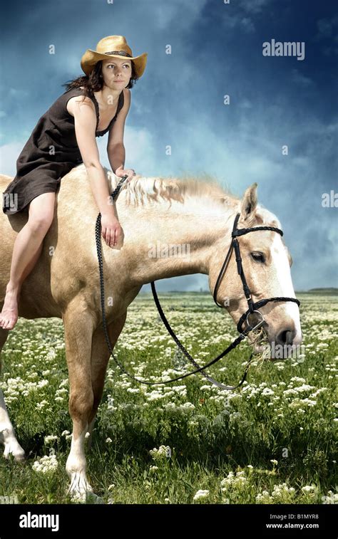 Portrait Of The Woman Feeding Her Horse With Grass Stock Photo Alamy