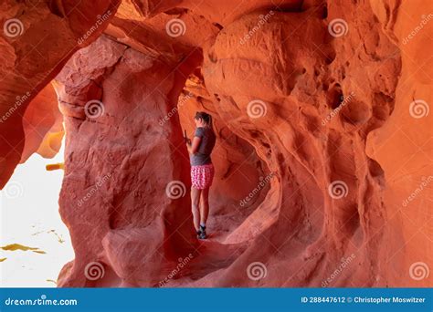 Valley Of Fire Woman Standing In The Fire Cave And Windstone Arch In Valley Of Fire State Park