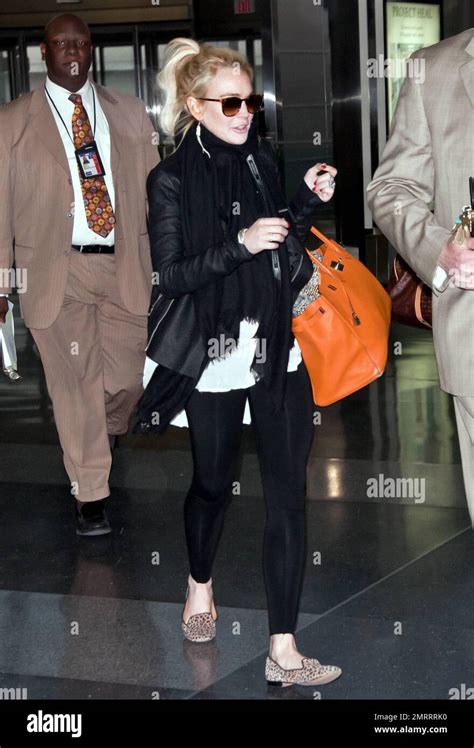 Lindsay Lohan Looks To Be In Good Spirits As She Heads For A Flight At