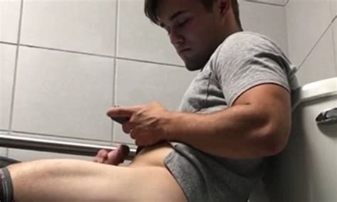 Cute Guy Caught Jerking Off In A Public Toilet By Hidden Camera