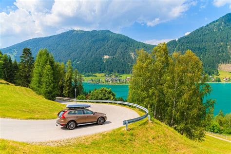 Car On Scenic Mountain Road Driving Along Weissensee Lake In Summer