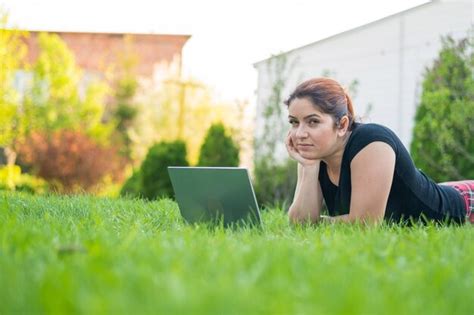 Premium Photo A Woman Lies On Her Stomach On The Lawn At The Cottage