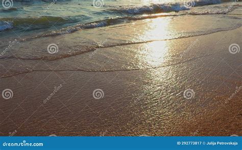 Calm Waves Roll Over The Sandy Shore Sunset At Sea Or Ocean Water