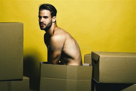 Guy With Naked Torso Sits Among Boxes Delivery And Moving Concept Stock Image Image Of Muscle