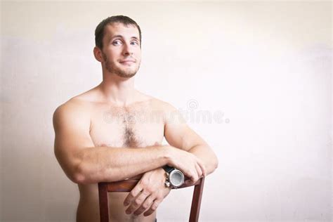 Portrait Of Thoughtful Attractive Man Sitting On A Chair Stock Photo