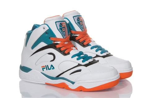 A Pair Of White And Blue Sneakers With Orange Laces