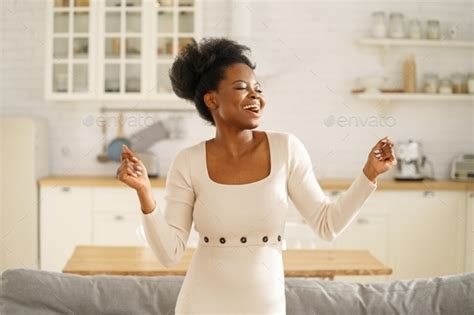 Happy Black Girl Wear Fashion Dress Dancing Enjoying Listening To Music Having Fun Alone At