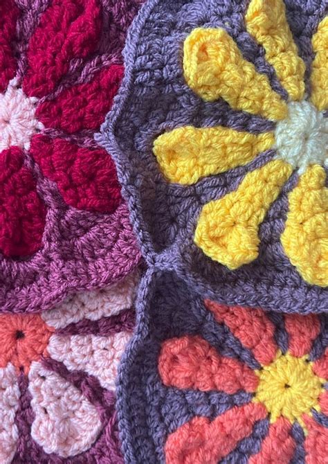 Crocheted Flowers Are Arranged On Top Of Each Other In Different Colors