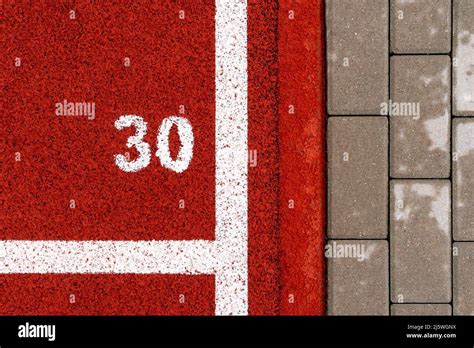 Sidewalk Near The Rubber Running Track With 30m Mark Stock Photo Alamy