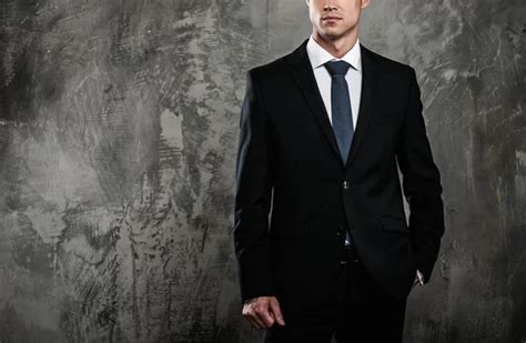 Well Dressed Man In Black Suit Against Grunge Wall Stock Photo By