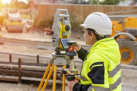 A Woman Site Engineer Surveyor Working With Theodolite Total Station