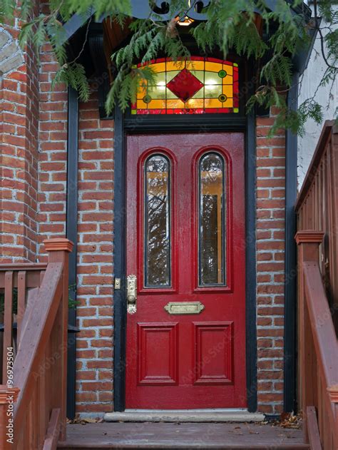 Old Red Door Of Victorian House With Stained Glass Transom Stock Photo