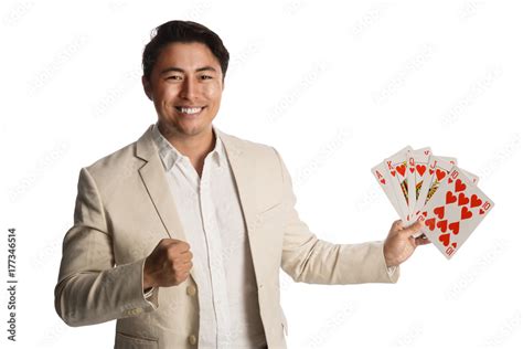 Laughing Man Wearing A Beige Suit Holding A Fan Of Cards In His Hands