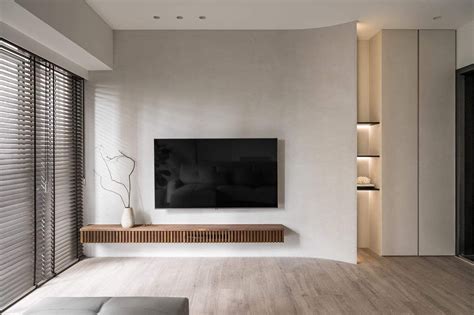 A Living Room With White Walls And Wooden Flooring Has A Flat Screen Tv