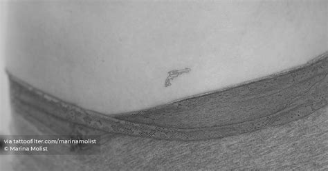 Fine Line Style Revolver Tattoo Located On The Hip