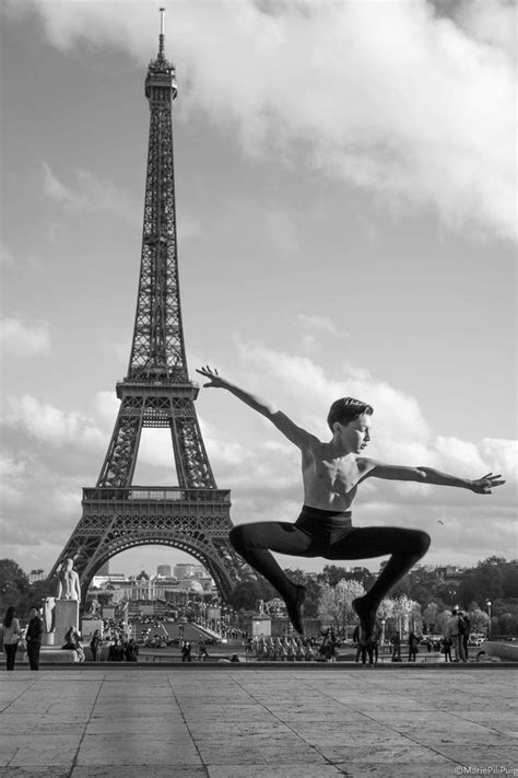 A Man Is Jumping In Front Of The Eiffel Tower