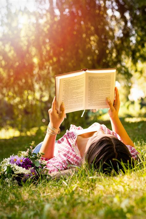 Girl Laying In Grass Reading