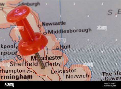 A Red Pin Stuck Into A Map Of Western Europe Pinpointing The Location