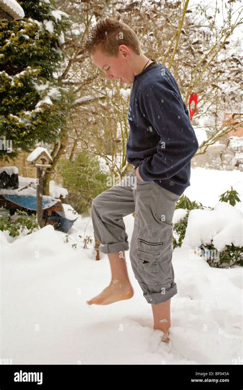 Teenage Boy Walking Barefoot Through Snow Stock Photo Alamy