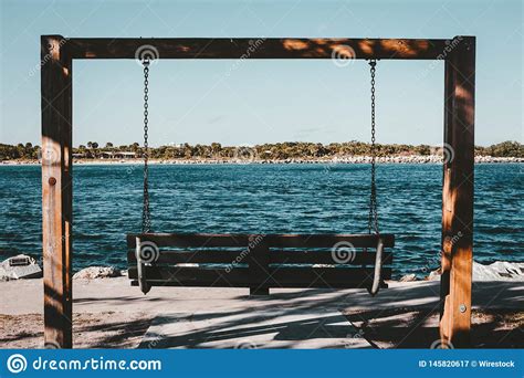 A Two Person Swing At The Coast Of A River Stock Image Image Of Beach