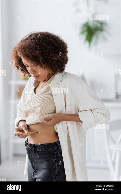 Young African American Woman With Diabetes Holding Syringe While Doing