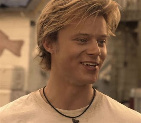 A Close Up Of A Person Wearing A Necklace