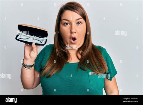 Beautiful Brunette Plus Size Woman Holding Glasses In Eyewear Case Scared And Amazed With Open