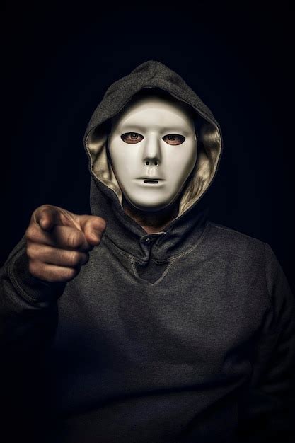 Premium Photo Hacker With White Mask With Hand Pointing To The Camera