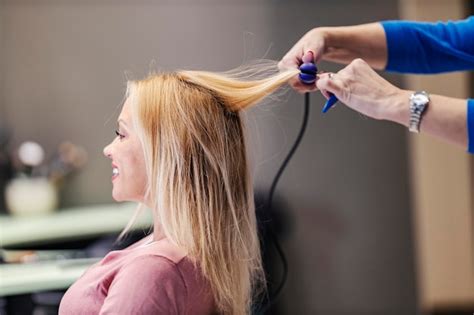 Premium Photo Cropped Picture Of A Hair Stylist Ironing Her Hair In A