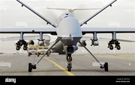 An Armed Mq Reaper Unmanned Aerial Vehicle Taxis Down Runway In