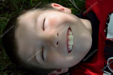 Boy Laying In Grass Smiling Pretending To Be Asleep — Stock Photo