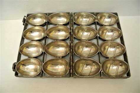 An Old Metal Tray Filled With Silver Spoons