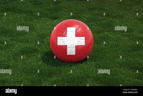 Soccer ball with Switzerland flag colors at a stadium on green grasses ...