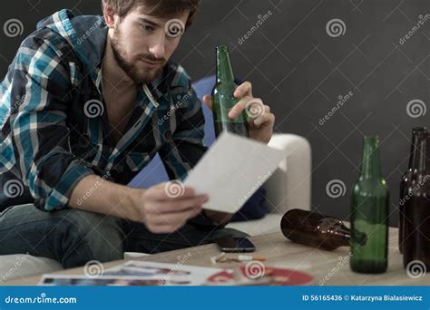 Man Drinking Alcohol And Looking At Photos Stock Photo Image Of