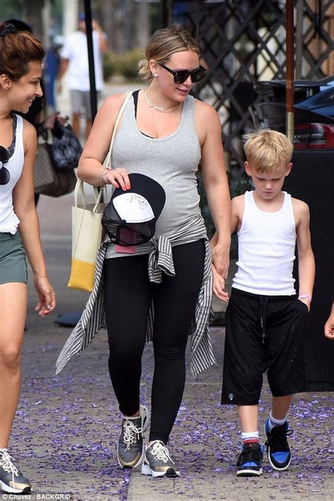 Hilary Duff Shows Off Her Growing Baby Bump In Fitted Gray Top With