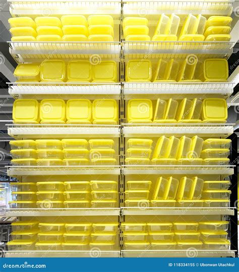 Stack Of Yellow Food Containers On Shelves In Shopping Mall Stock Image