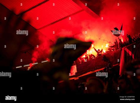 Football Hooligans With Mask Holding Torches In Fire While Supporting