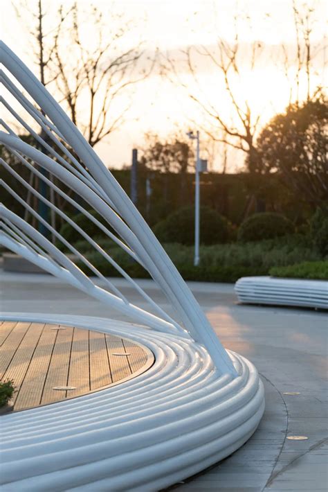 A White Sculpture Sitting On Top Of A Wooden Floor Next To A Park