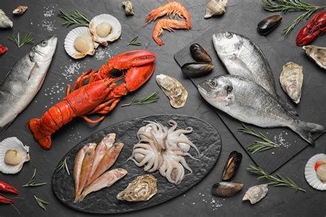 Premium Photo Fresh Fish And Different Seafood On Black Table Flat Lay