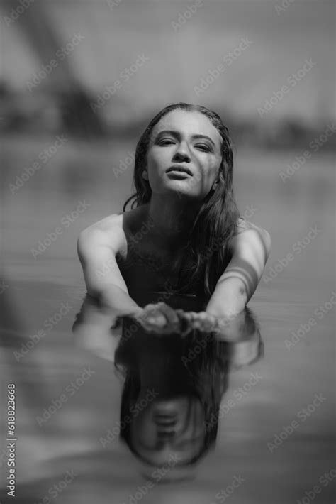 Black And White Portrait Of Naked Woman Swimming In A Lake Stock Photo