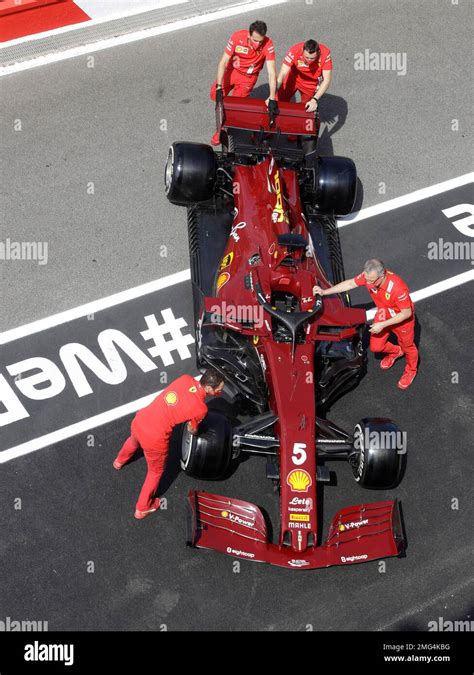 Pit Crew Wheel The Car Of Ferrari Driver Sebastian Vettel Of Germany At