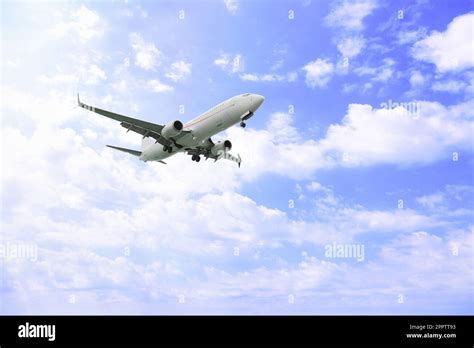 Airplane Flying High In Blue Sky Modern Aircraft Stock Photo Alamy