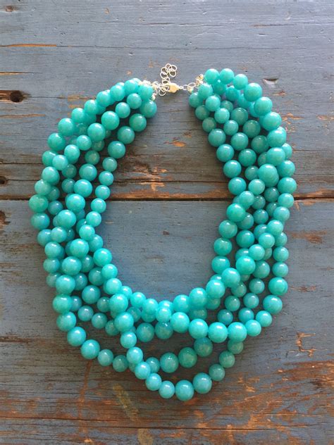 Bright Turquoise Beaded Necklace Featuring 5 Strands Of Lightweight