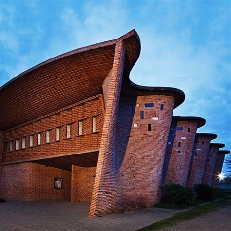 The Building Is Made Out Of Bricks And Has A Curved Roof