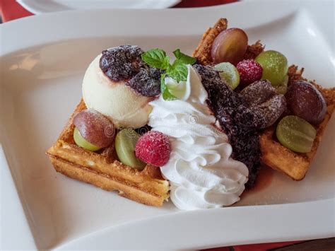 Delicious Waffles With Fresh Fruits Ice Cream And Whipped Cream Stock