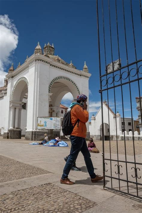 An Unidentified Walks In Front Of The Basilica Our Lady Of Copacabana