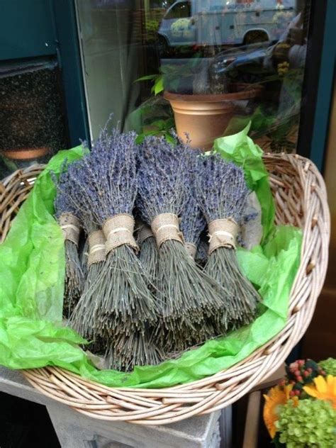 Three Lavender Brushes Sitting In A Wicker Basket On Top Of A Table