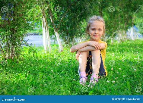 Little Girl Sitting In The Grass Stock Image Image Of Blond Girl