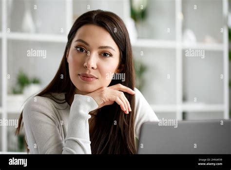 Portrait Of A Brunette Woman Working In An Office With A Laptop