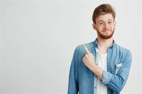 Free Photo Portrait Of Cheerful Young Handsome Guy Smiling Pointing